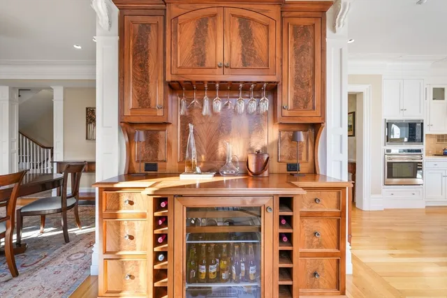 a view of a kitchen with stainless steel appliances granite countertop a stove and a wooden cabinets
