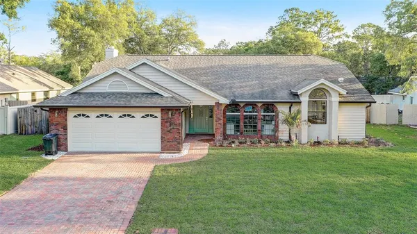 a front view of a house with a garden and yard