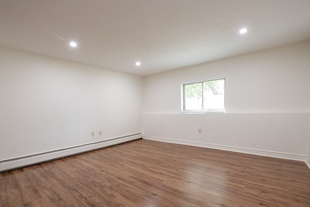 146 Willow Street, Unit 4 Waltham, MA 02453 - Photo 10 of 13 wooden floor in an empty room with a window