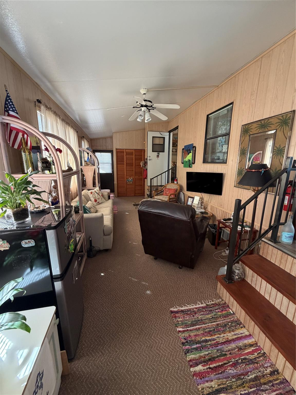 6444 Southeast 56th Street Okeechobee, FL 34974 - Photo 3 of 13 a living room with furniture and a flat screen tv