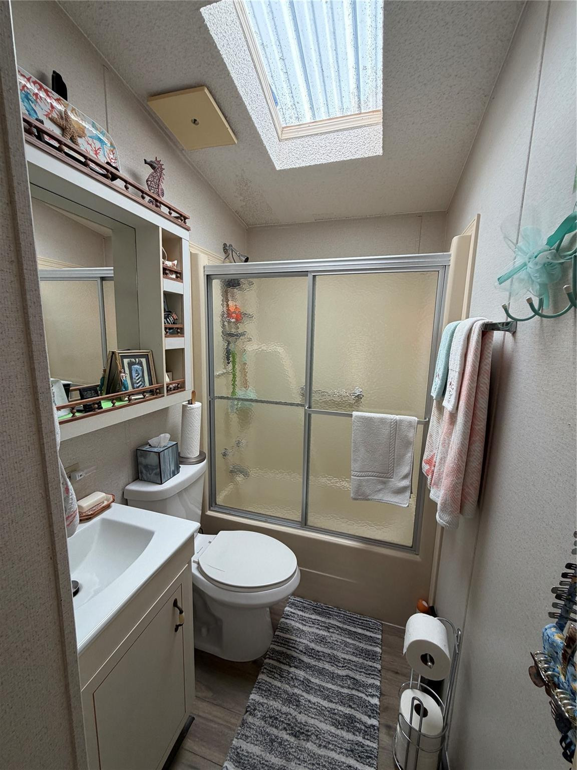 6444 Southeast 56th Street Okeechobee, FL 34974 - Photo 9 of 13 a bathroom with a toilet a sink and glass door