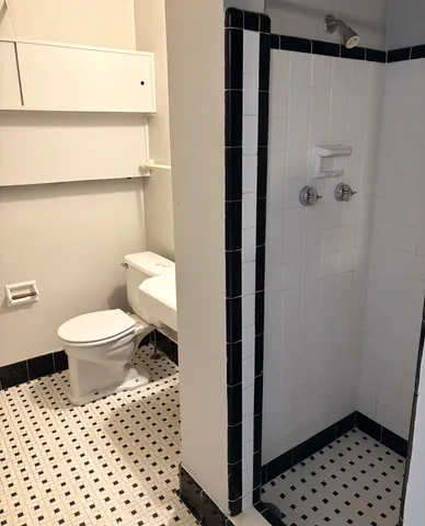 a view of hallway with furniture and a refrigerator