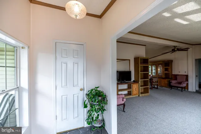 a view of a livingroom with furniture and a window