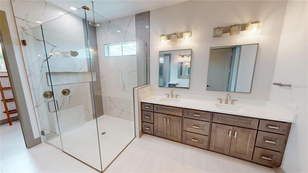 2049 Treasure Lane Punta Gorda, FL 33982 - Photo 31 of 72 a bathroom with a double vanity sink a large mirror and shower