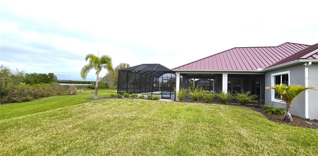 2049 Treasure Lane Punta Gorda, FL 33982 - Photo 53 of 72 a view of a house with a yard and table and chairs under an umbrella