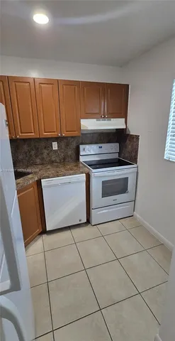 a stove top oven sitting inside of a kitchen