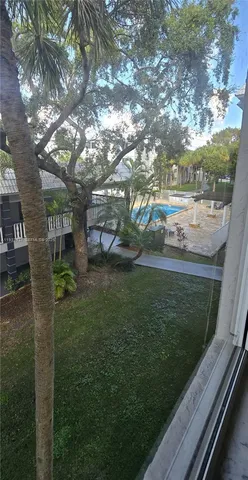 a backyard of a house with lots of green space table and chairs
