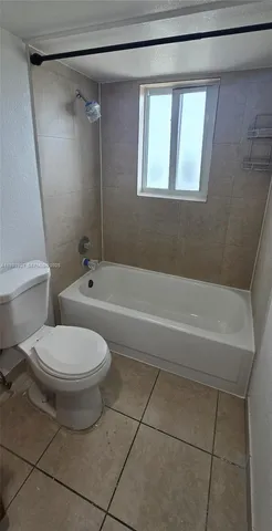 a bathroom with a toilet a sink and bathtub