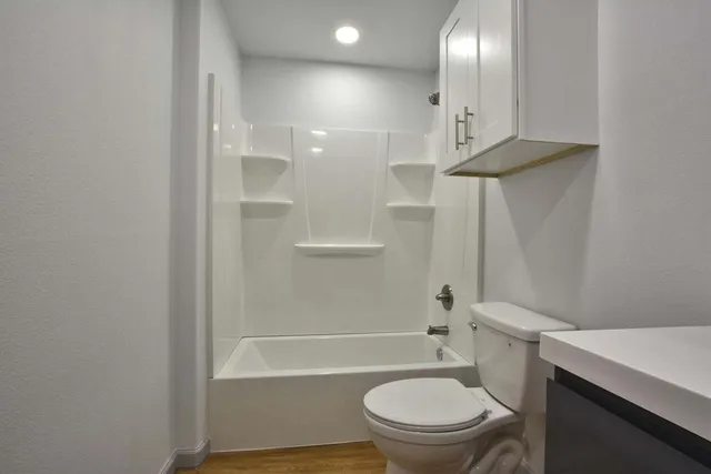 a bathroom with a toilet a sink and bathtub