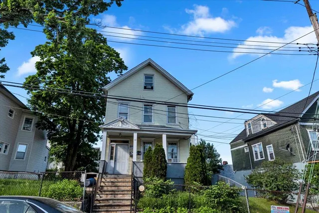 a front view of a house with a garden