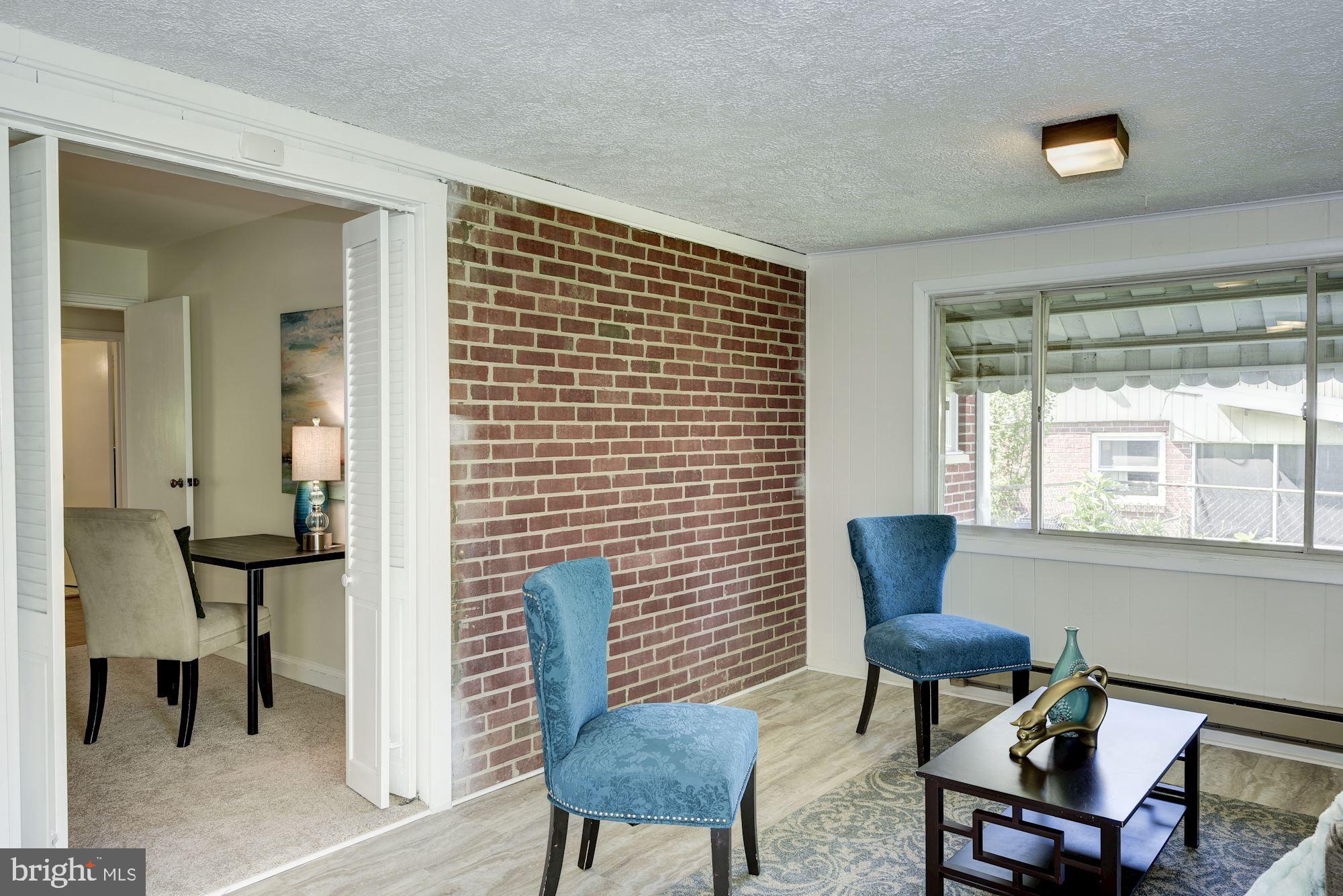 9816 Cottrell Terrace Silver Spring, MD 20903 - Photo 10 of 22 Exposed brick in sunroom