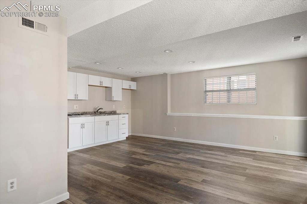 2531 Blazek Loop Colorado Springs, CO 80918 - Photo 12 of 29 a room with a white cabinets and wooden floor