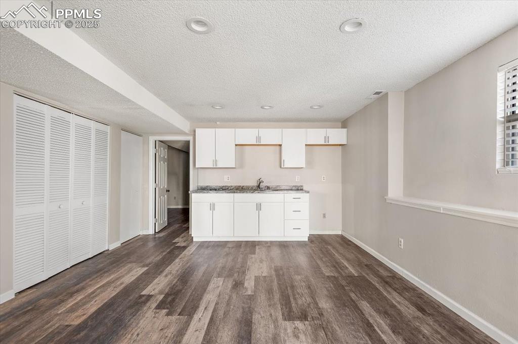 2531 Blazek Loop Colorado Springs, CO 80918 - Photo 13 of 29 a view of a kitchen with wooden floor and electronic appliances