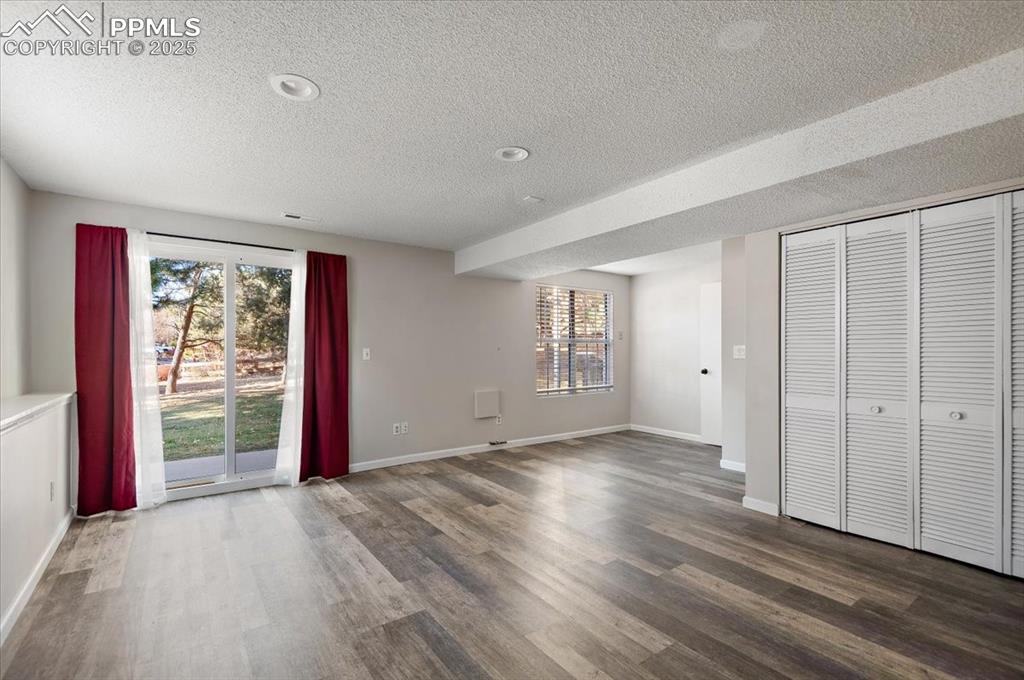 2531 Blazek Loop Colorado Springs, CO 80918 - Photo 14 of 29 an empty room with wooden floor and windows