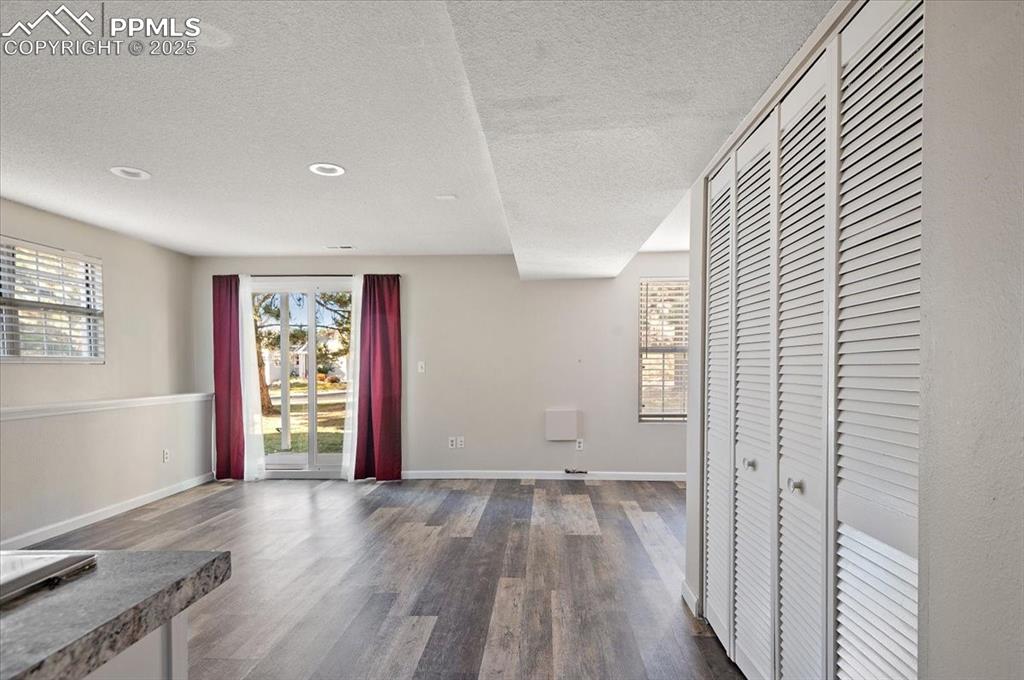 2531 Blazek Loop Colorado Springs, CO 80918 - Photo 17 of 29 an empty room with wooden floor and windows