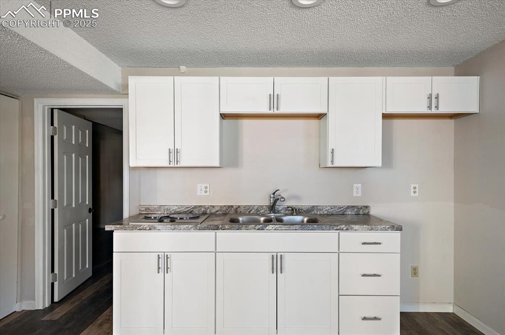 2531 Blazek Loop Colorado Springs, CO 80918 - Photo 18 of 29 a kitchen with granite countertop white cabinets and white appliances