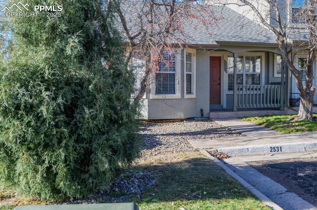 2531 Blazek Loop Colorado Springs, CO 80918 - Photo 19 of 29 a front view of a house with a yard and glass windows