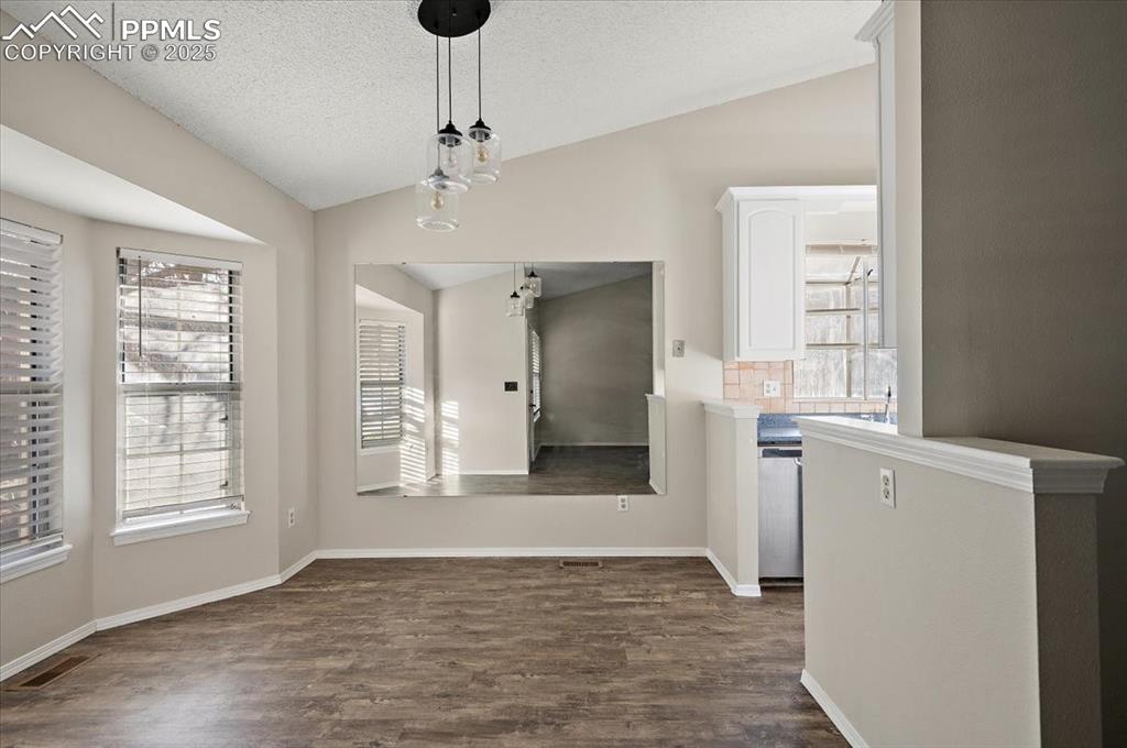 2531 Blazek Loop Colorado Springs, CO 80918 - Photo 2 of 29 a view of an empty room with window and wooden floor