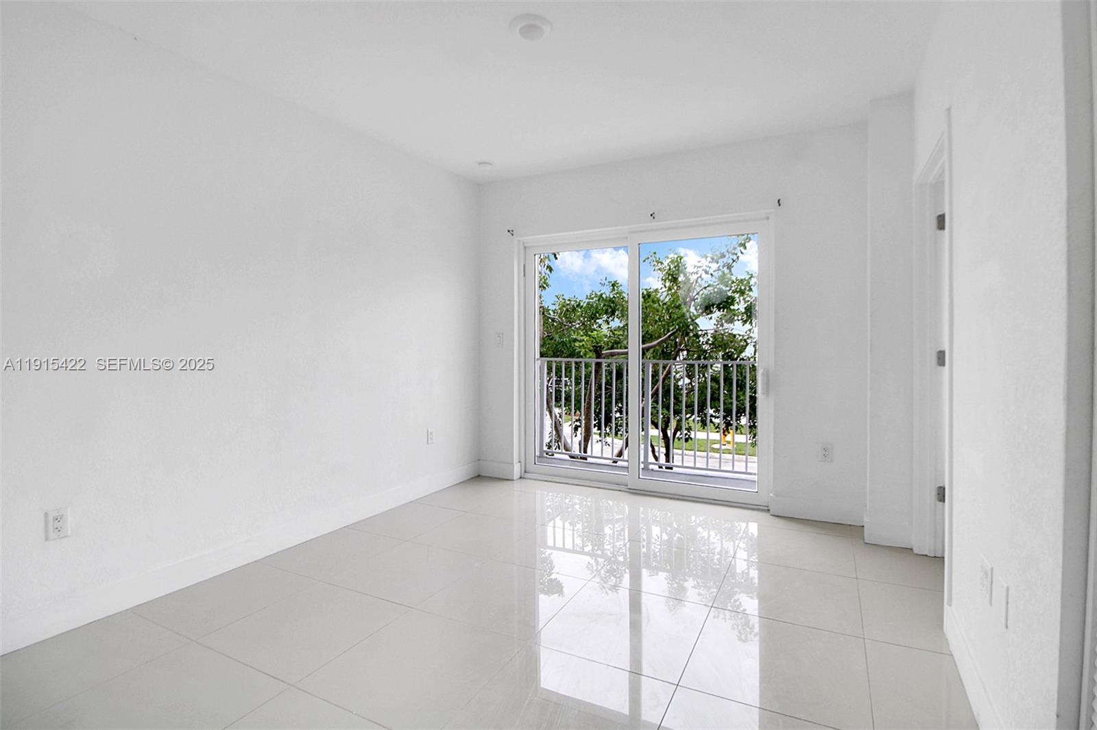 14482 Southwest 259th Street Homestead, FL 33032 - Photo 15 of 35 a view of an empty room with wooden floor and a window