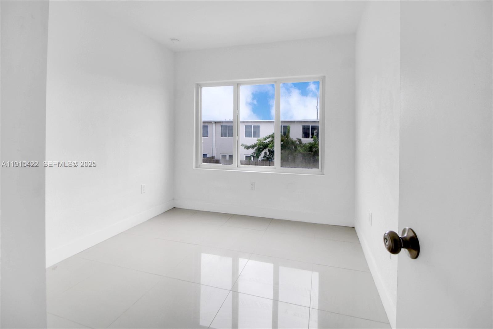 14482 Southwest 259th Street Homestead, FL 33032 - Photo 19 of 35 a view of a room that has a window in it
