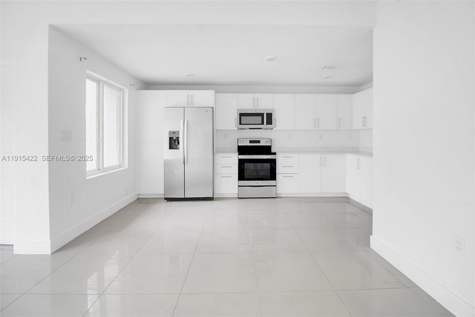 14482 Southwest 259th Street Homestead, FL 33032 - Photo 2 of 35 a view of a kitchen with a sink and a refrigerator