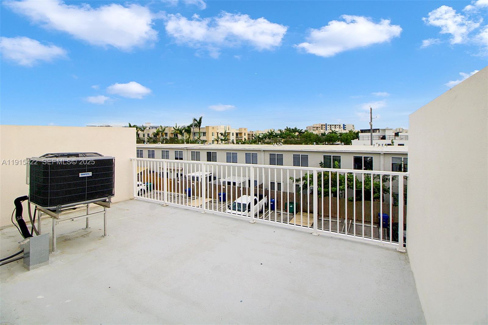 14482 Southwest 259th Street Homestead, FL 33032 - Photo 23 of 35 a view of a balcony with chair and iron fence
