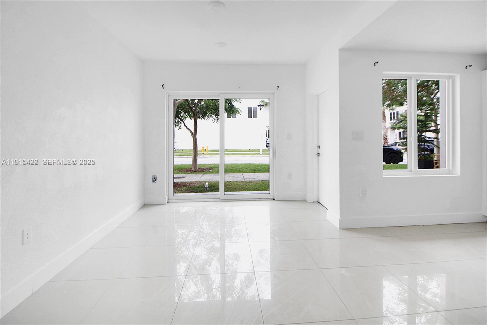 14482 Southwest 259th Street Homestead, FL 33032 - Photo 3 of 35 a view of an empty room with a window