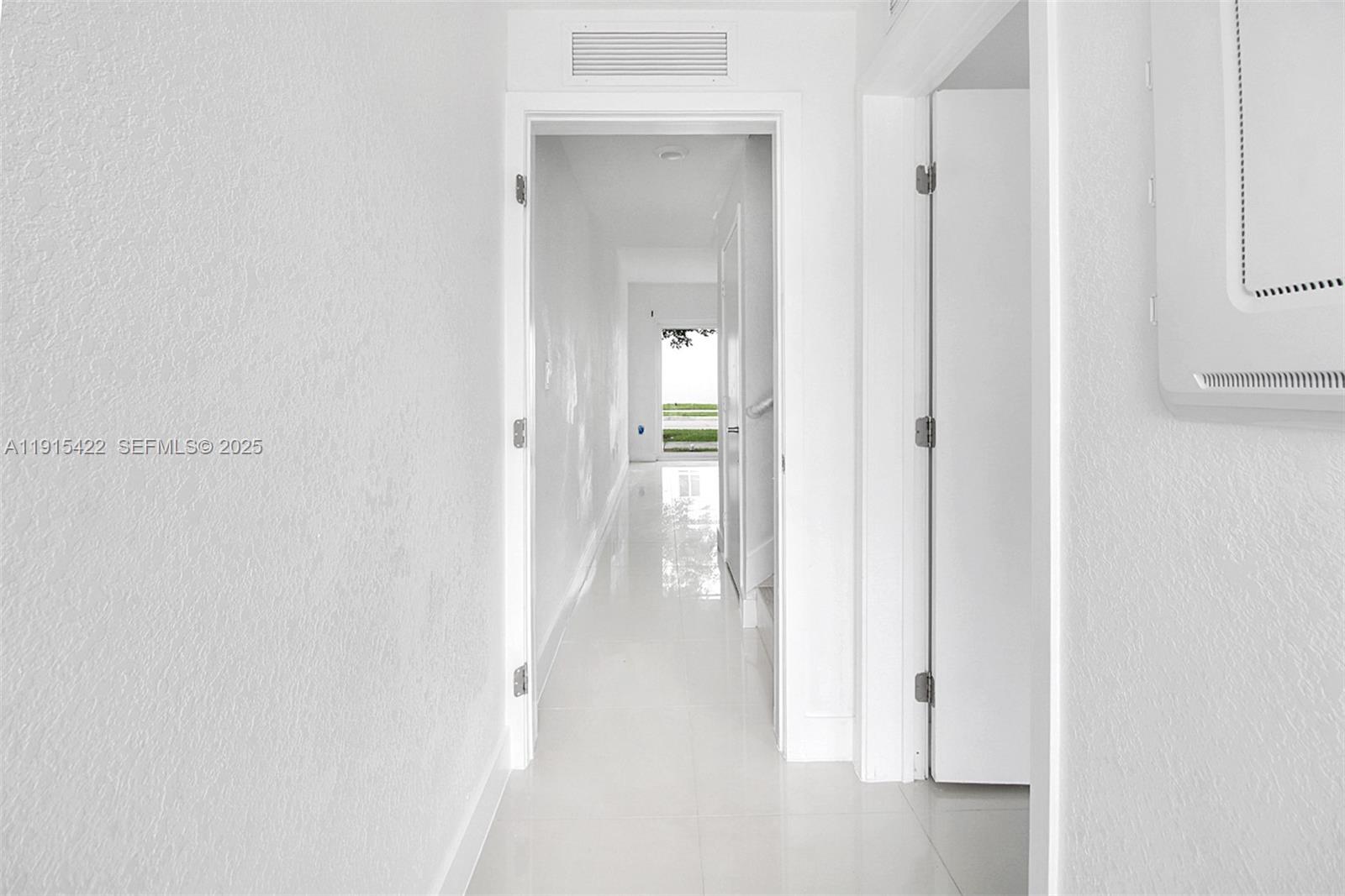 14482 Southwest 259th Street Homestead, FL 33032 - Photo 5 of 35 a view of a hallway with wooden floor and closet