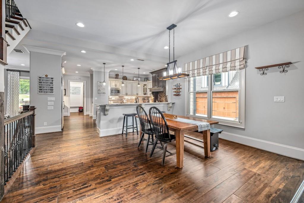 400 Harmony Road Eatonton, GA 31024 - Photo 22 of 136 a dining room with furniture and wooden floor
