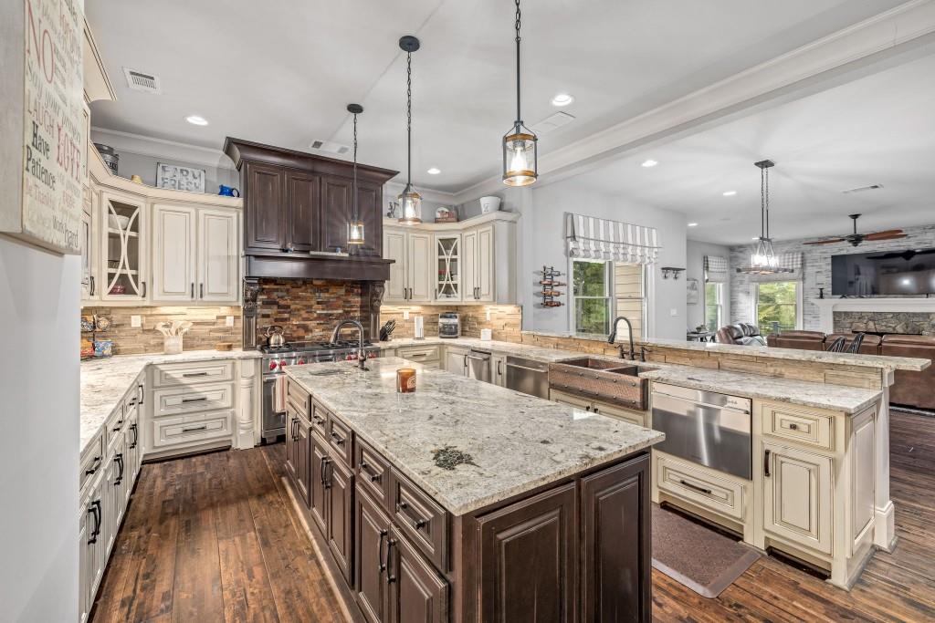 400 Harmony Road Eatonton, GA 31024 - Photo 23 of 136 a kitchen with stainless steel appliances granite countertop stove top oven and refrigerator