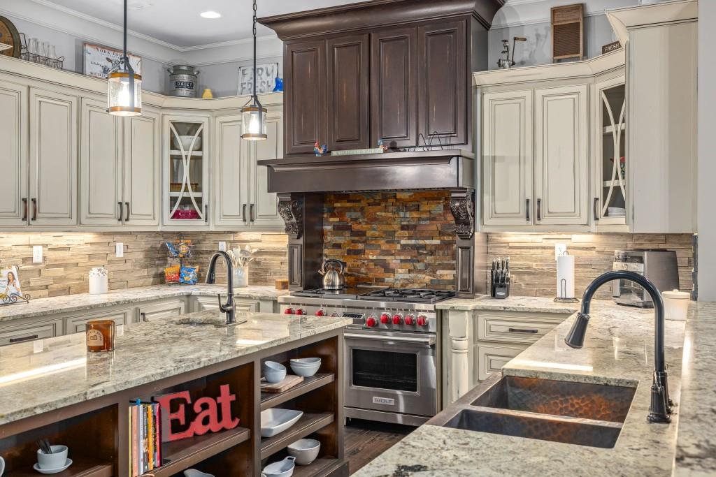 400 Harmony Road Eatonton, GA 31024 - Photo 24 of 136 a kitchen with stainless steel appliances granite countertop a stove and a sink