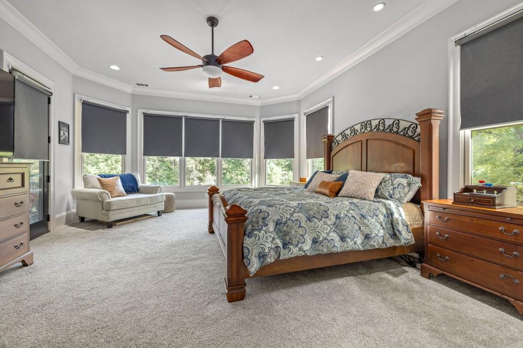 400 Harmony Road Eatonton, GA 31024 - Photo 32 of 136 a bedroom with a large bed and a large window