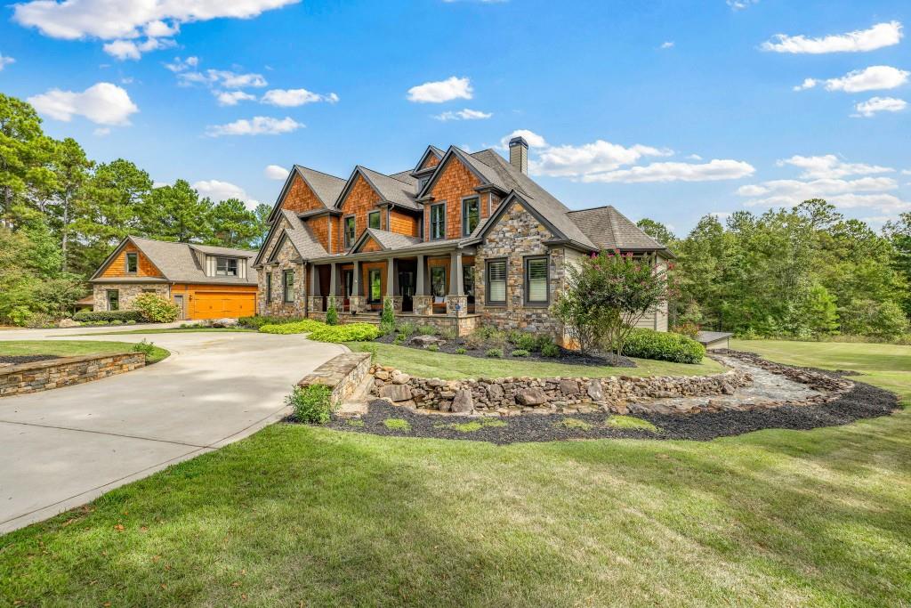 400 Harmony Road Eatonton, GA 31024 - Photo 4 of 136 a view of a white house with a big yard potted plants and large tree