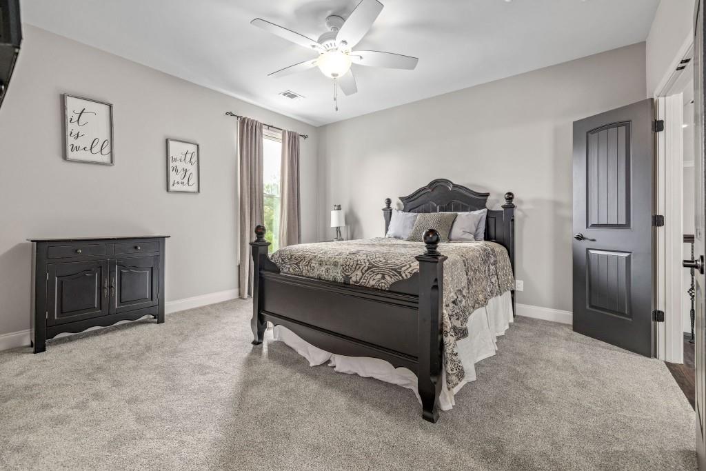 400 Harmony Road Eatonton, GA 31024 - Photo 49 of 136 a bed room with a bed and a chandelier