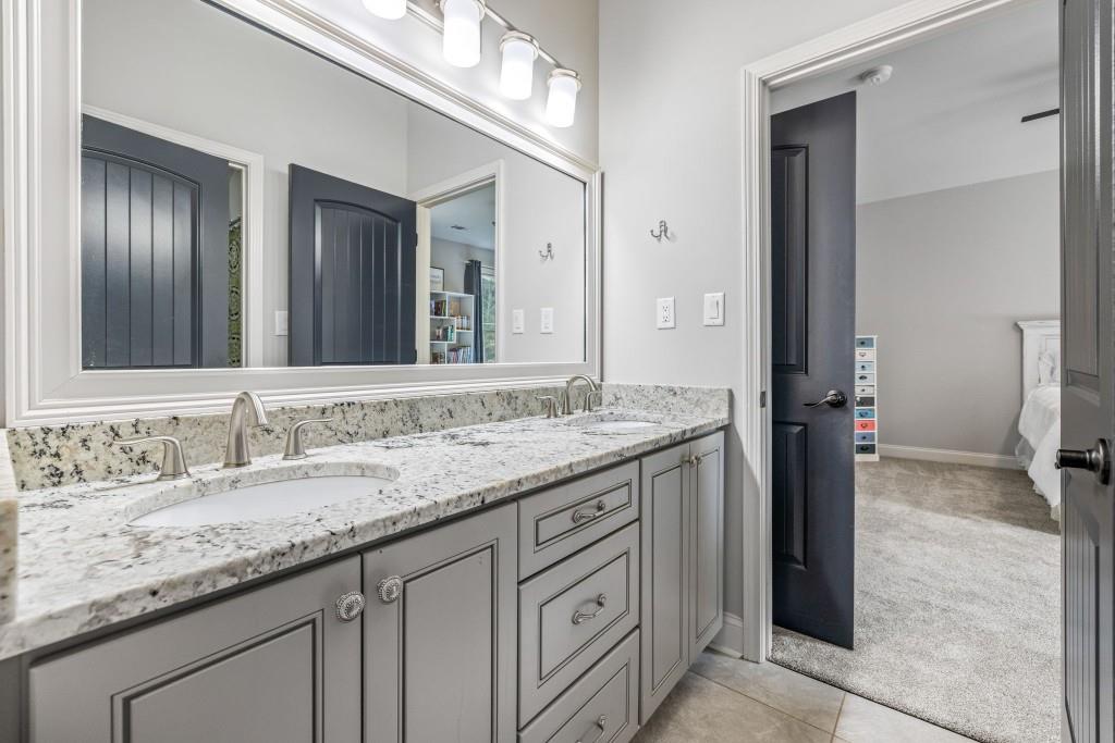 400 Harmony Road Eatonton, GA 31024 - Photo 53 of 136 a bathroom with a granite countertop double vanity sink and a mirror