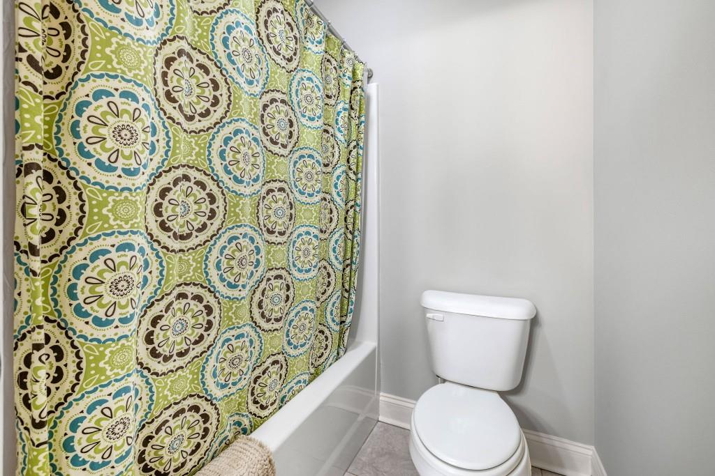 400 Harmony Road Eatonton, GA 31024 - Photo 54 of 136 a white toilet sitting next to a shower curtain