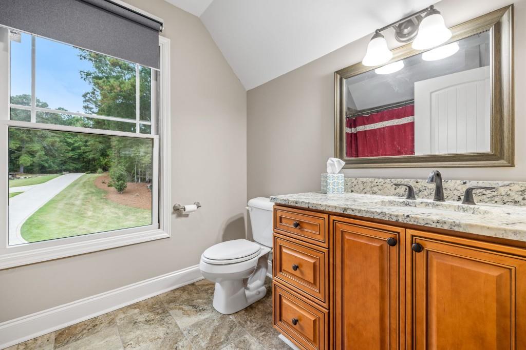 400 Harmony Road Eatonton, GA 31024 - Photo 94 of 136 a bathroom with a granite countertop toilet sink and mirror
