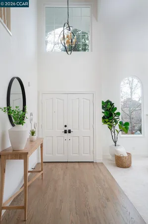 a large kitchen with a large window and wooden floor