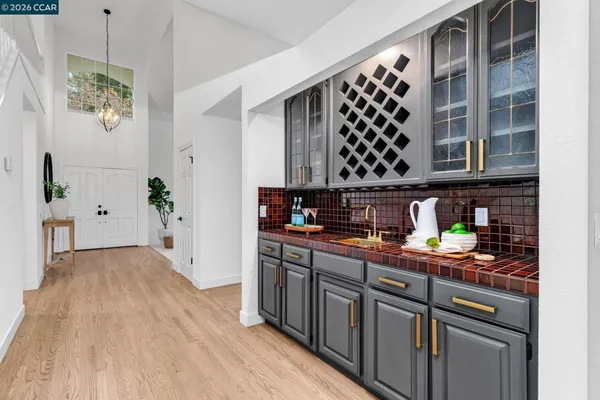 a large kitchen with stainless steel appliances granite countertop a stove a sink and a refrigerator