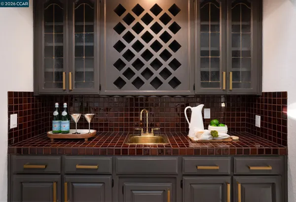 a kitchen with stainless steel appliances white cabinets a sink and a stove