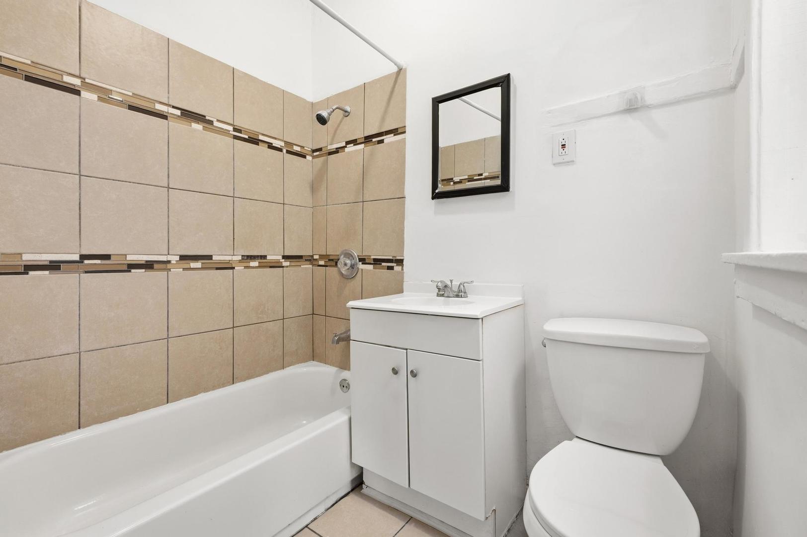 3752 West Division Street, Unit 3W Chicago, IL 60651 - Photo 11 of 11 a bathroom with a sink a toilet and shower