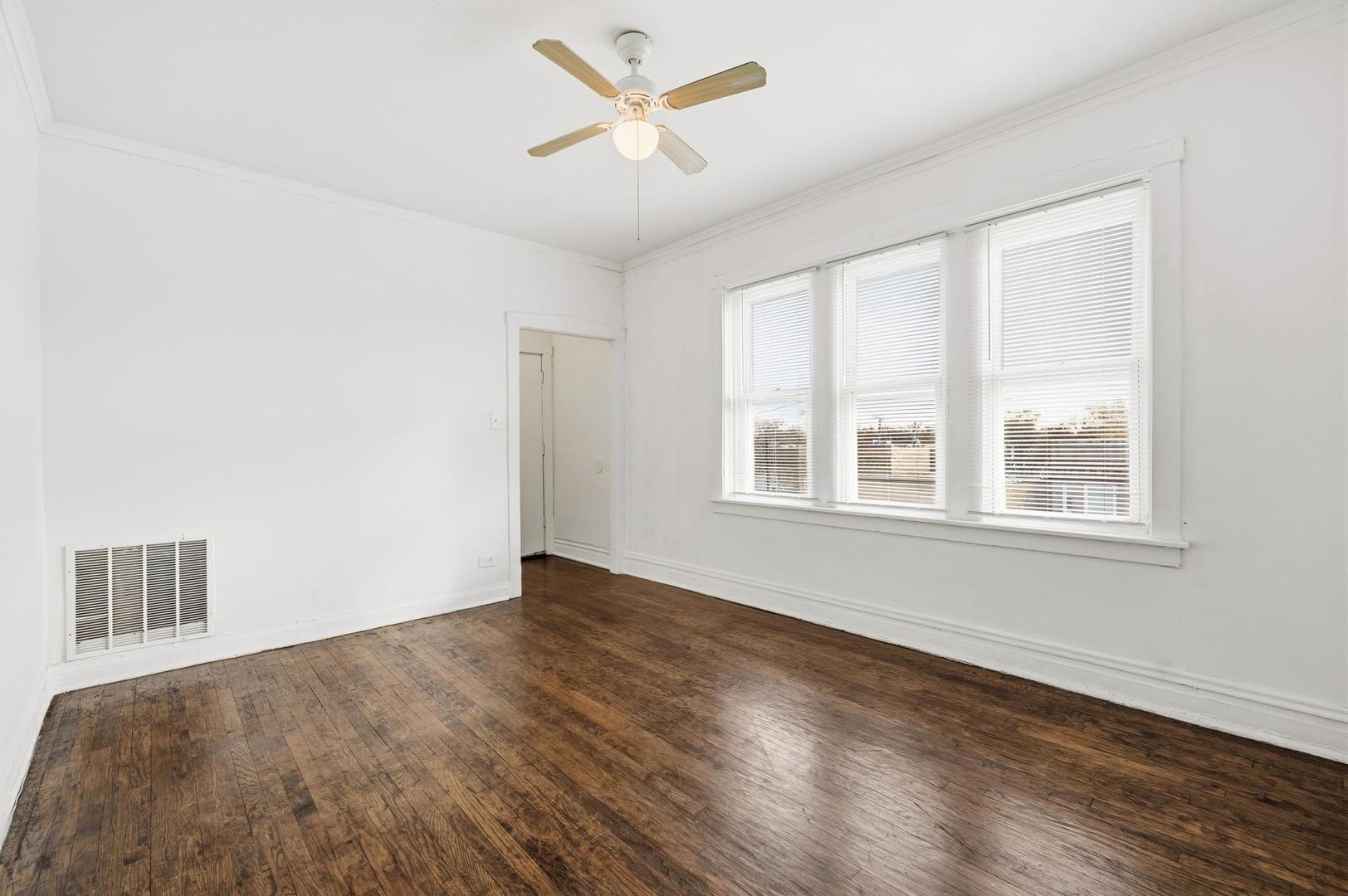 3752 West Division Street, Unit 3W Chicago, IL 60651 - Photo 2 of 11 a view of an empty room with a window and wooden floor