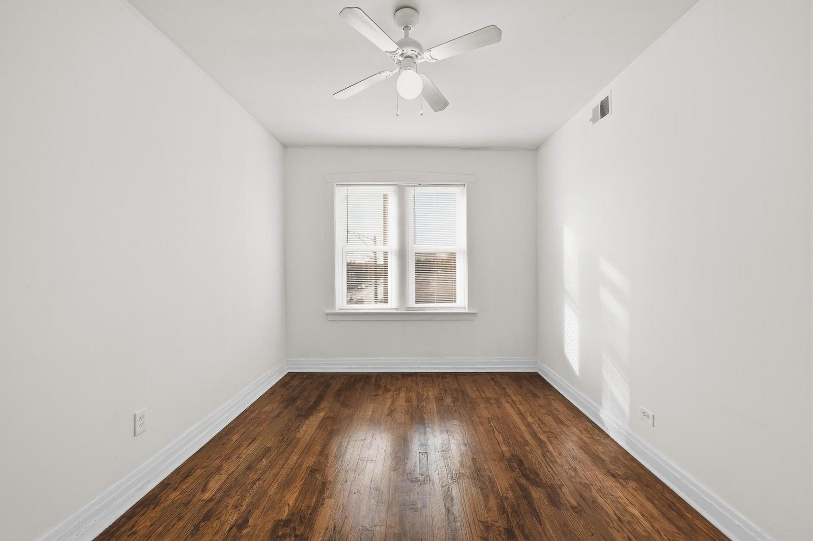 3752 West Division Street, Unit 3W Chicago, IL 60651 - Photo 8 of 11 an empty room with a window and wooden floor