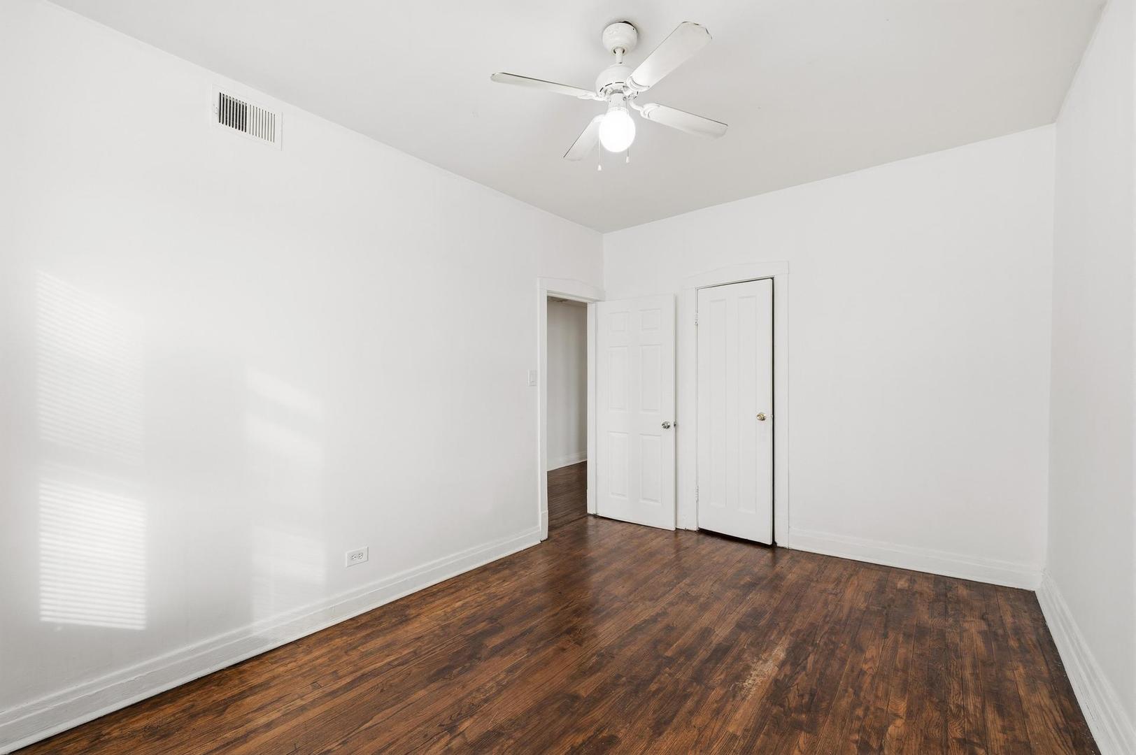3752 West Division Street, Unit 3W Chicago, IL 60651 - Photo 9 of 11 an empty room with wooden floor fan and window