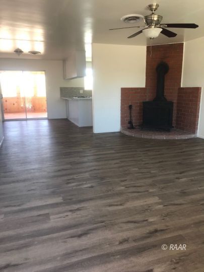 303 West Howell Avenue Ridgecrest, CA 93555 - Photo 2 of 22 a view of kitchen and empty room with wooden floor
