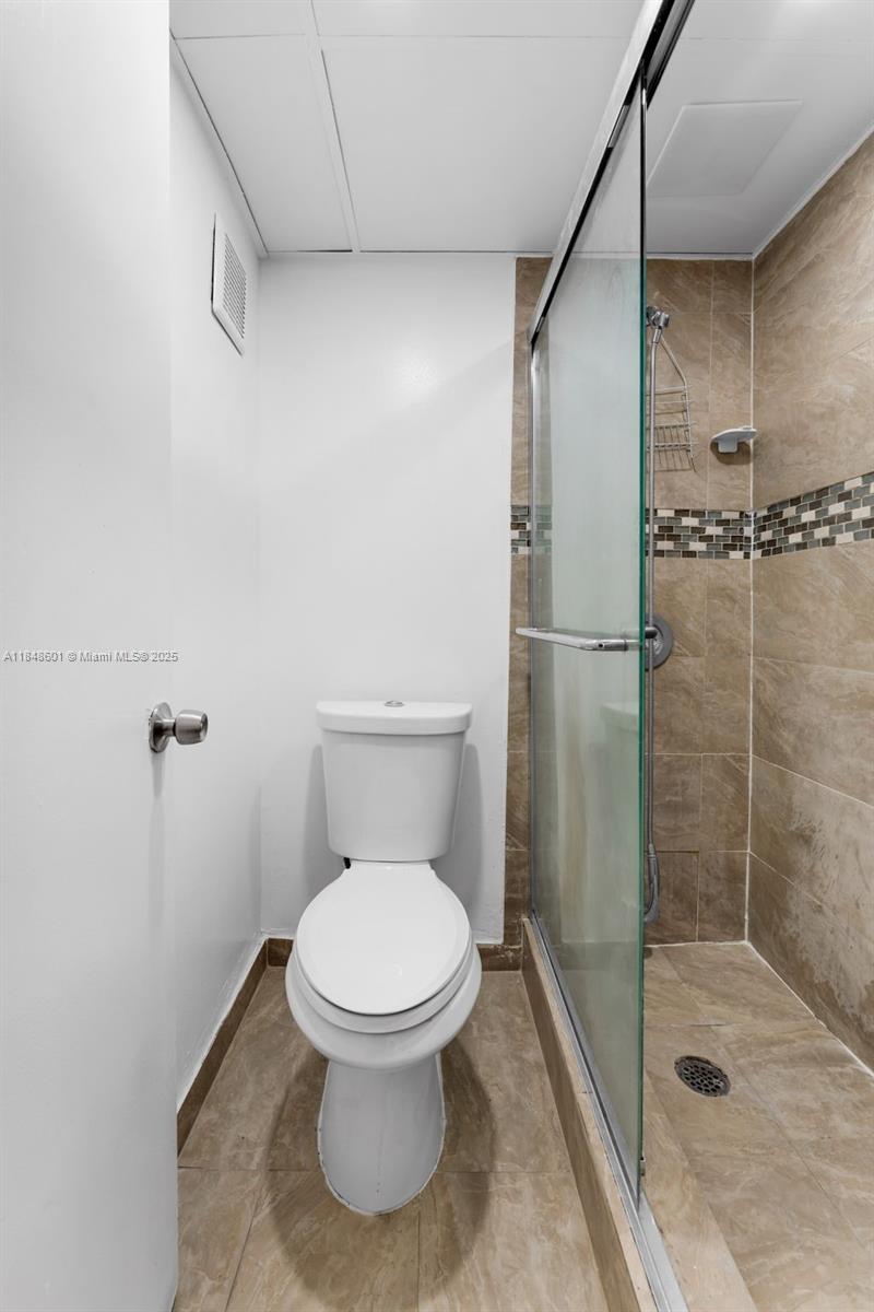 6911 Southwest 129th Avenue, Unit 2 Miami, FL 33183 - Photo 11 of 30 a white toilet sitting next to a bathroom sink