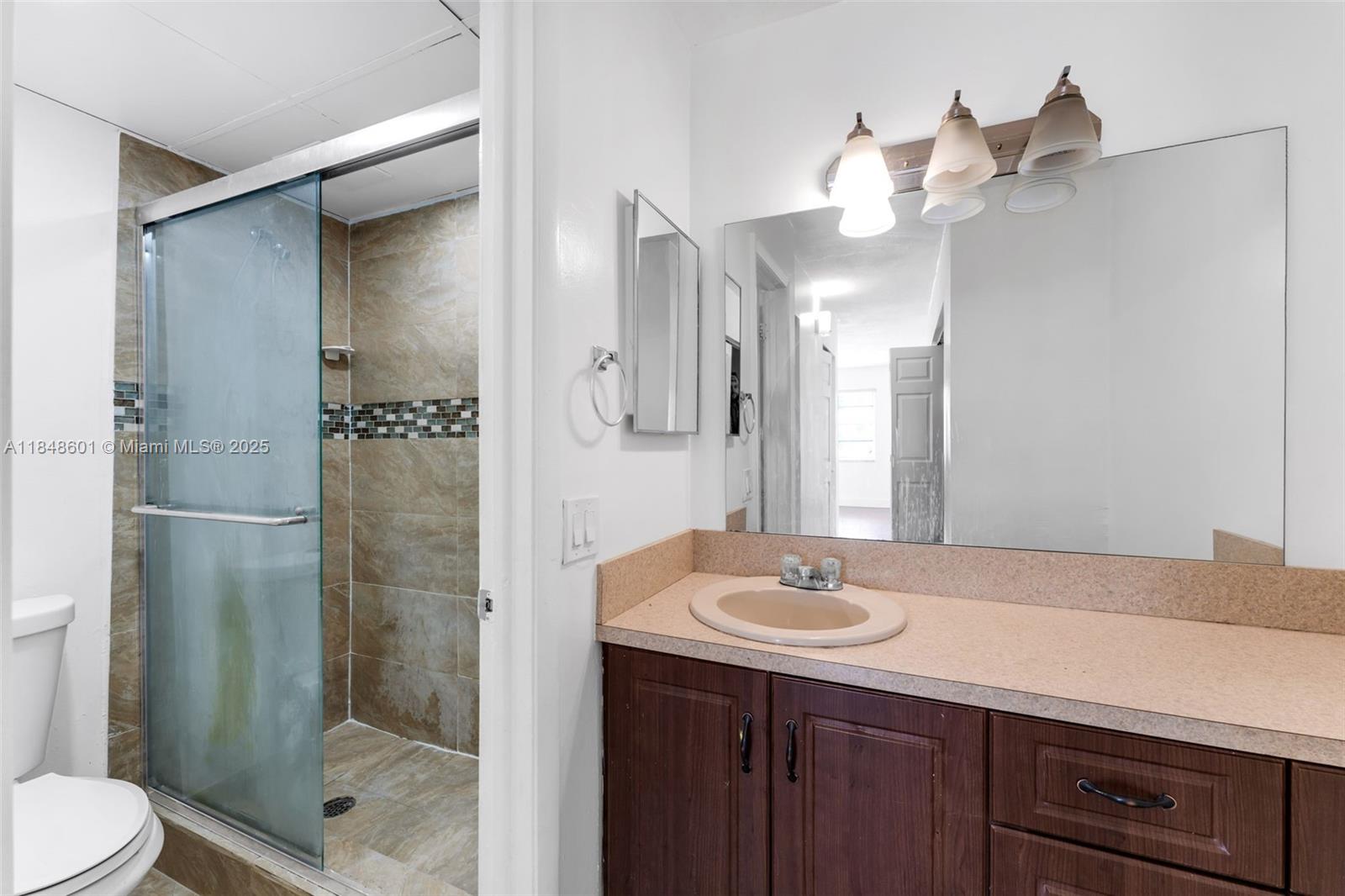 6911 Southwest 129th Avenue, Unit 2 Miami, FL 33183 - Photo 12 of 30 a bathroom with a sink shower and a mirror