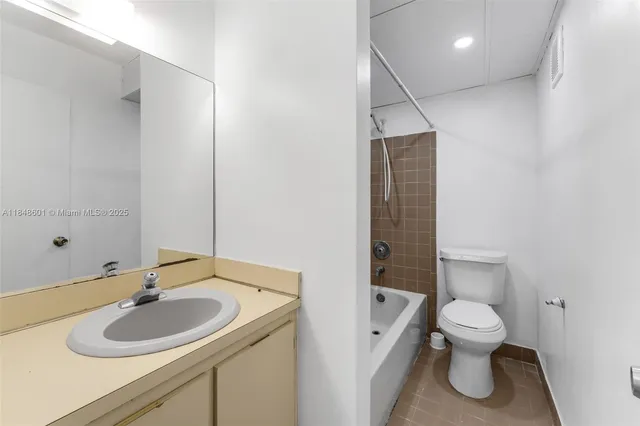 a bathroom with a toilet and a bathtub