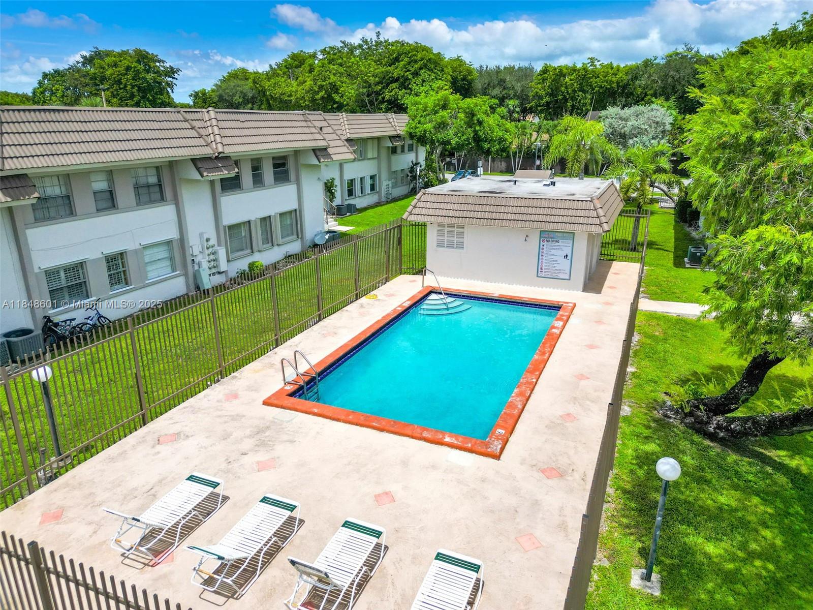 6911 Southwest 129th Avenue, Unit 2 Miami, FL 33183 - Photo 29 of 30 a view of a patio with a table and chairs