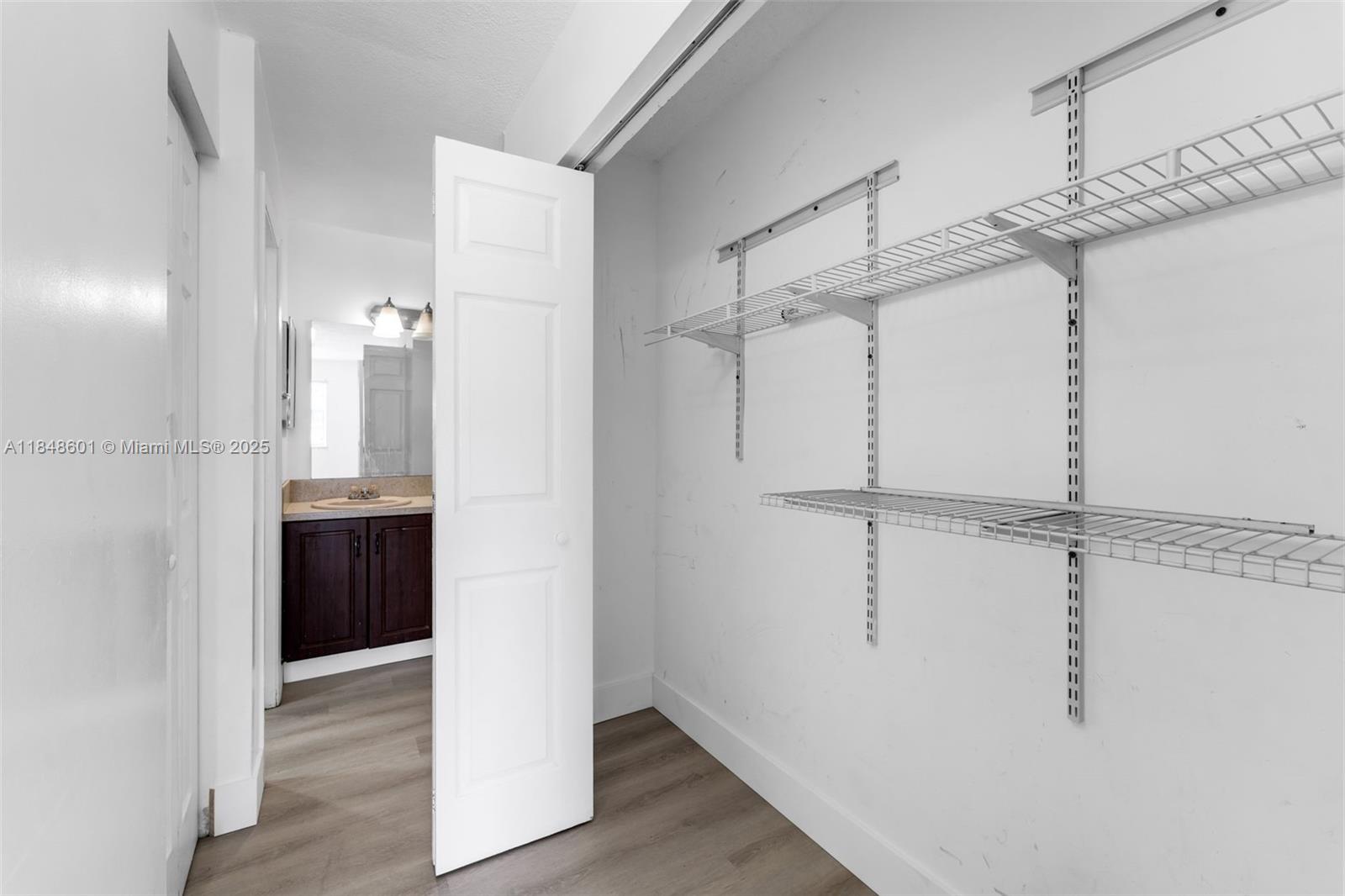 6911 Southwest 129th Avenue, Unit 2 Miami, FL 33183 - Photo 10 of 30 a view of a room with a walk in closet and wooden floor